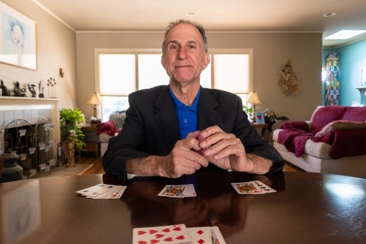Dr. Eliot Jacobson sitting at his desk with cards