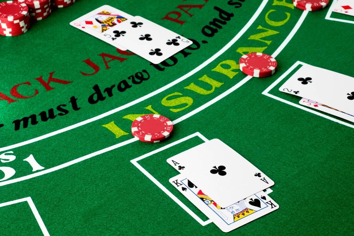 playing cards on a table each with a side bet
