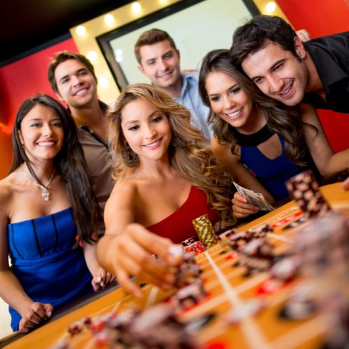 people betting chips on a roulette table people betting chips on a roulette table