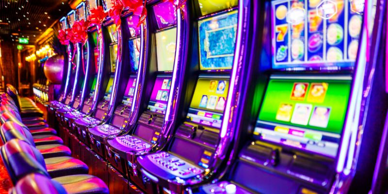 slot machines lined up in a row at a casino slot machines lined up in a row at a casino