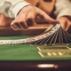 Blackjack dealer shifting deck of cards on casino table