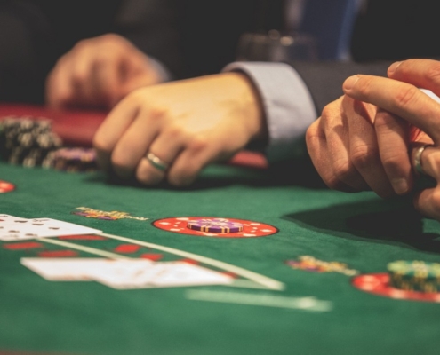 Hand of Blackjack players at the casino table