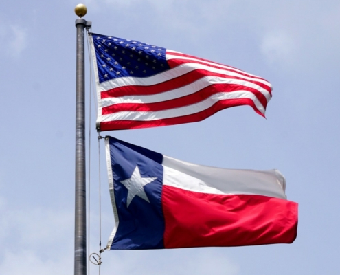 USA flag flying above Texas state flag
