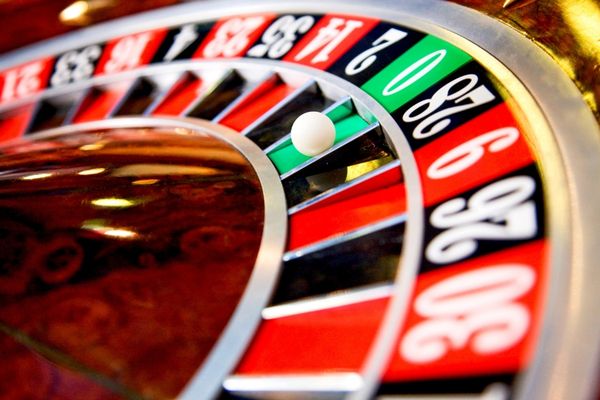 a close up shot of a roulette table with a white ball in the green pcoket