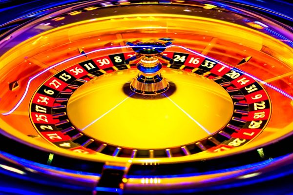 a neon roulette table glowing under a light source