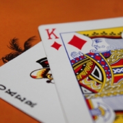 Joker and king of diamonds on red casino table