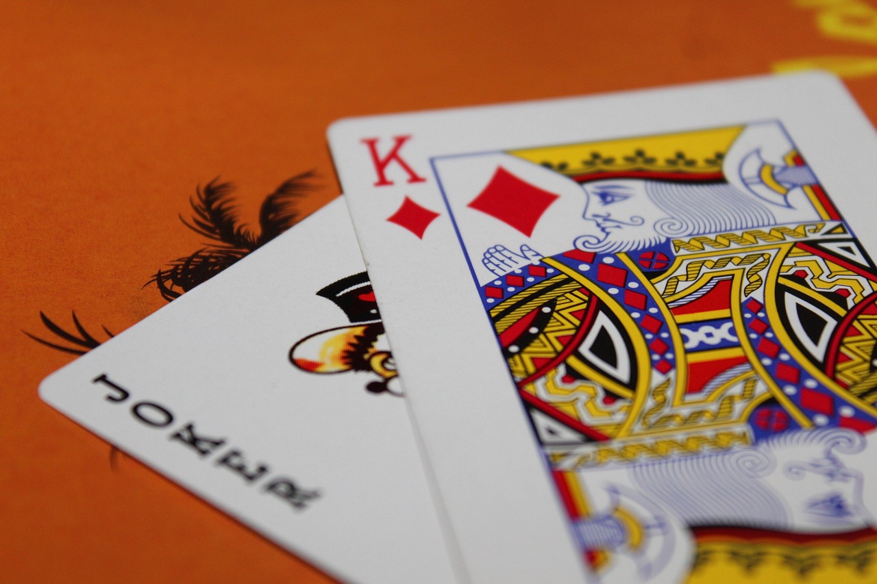 Joker and king of diamonds on red casino table