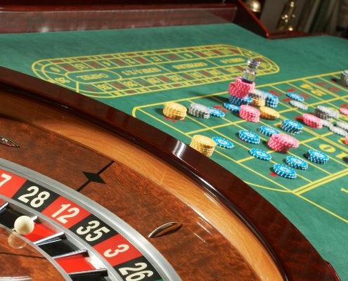Live roulette table spinning next to a table of chips
