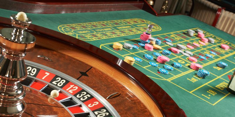 Live roulette table spinning next to a table of chips