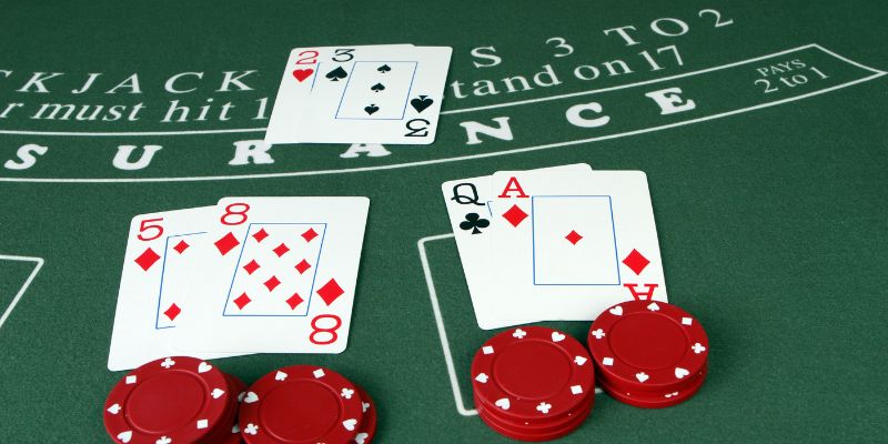 Blackjack insurance example displayed with cards and casino chips on green blackjack table