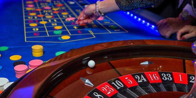 a close up view of a roulette table with a blue mat with chips on it
