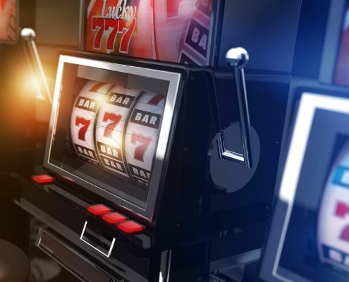 three slot machines with winning slot reels